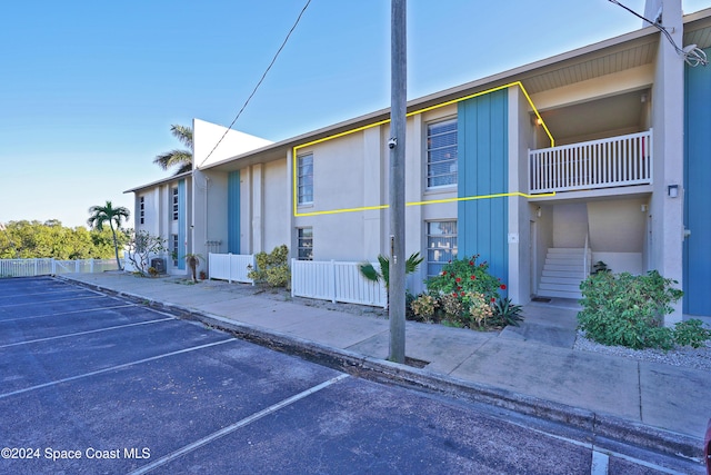 250 N Banana River Dr Unit H-8, Merritt Island, FL 32952 - view of home's exterior with uncovered parking and stairway