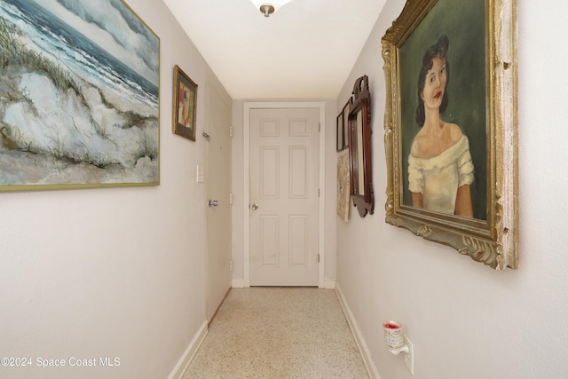 250 N Banana River Dr Unit H-8, Merritt Island, FL 32952 - hall featuring baseboards and speckle patterned floor