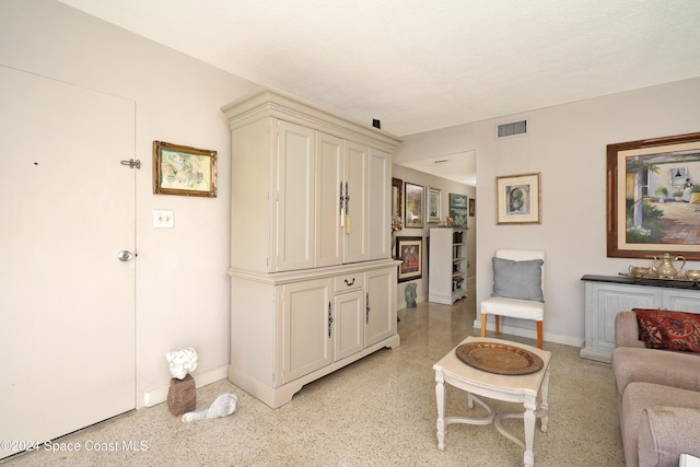 250 N Banana River Dr Unit H-8, Merritt Island, FL 32952 - living room featuring dark aggregate flooring and baseboards