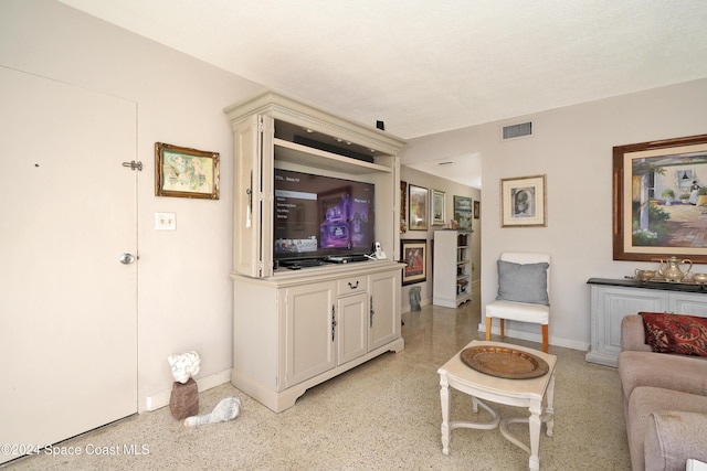 250 N Banana River Dr Unit H-8, Merritt Island, FL 32952 - living area featuring baseboards and dark aggregate flooring