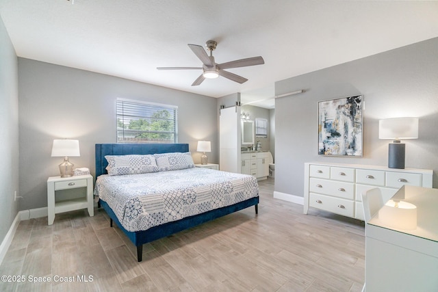 1237 Glenham Dr NE, Palm Bay, FL 32905 - bedroom with baseboards, light wood finished floors, a ceiling fan, and ensuite bathroom