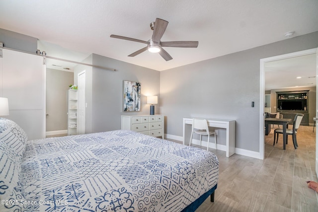 1237 Glenham Dr NE, Palm Bay, FL 32905 - bedroom with baseboards, light wood-style floors, and a ceiling fan