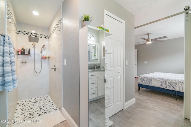 1237 Glenham Dr NE, Palm Bay, FL 32905 - full bath with a tile shower, vanity, wood finished floors, and ceiling fan