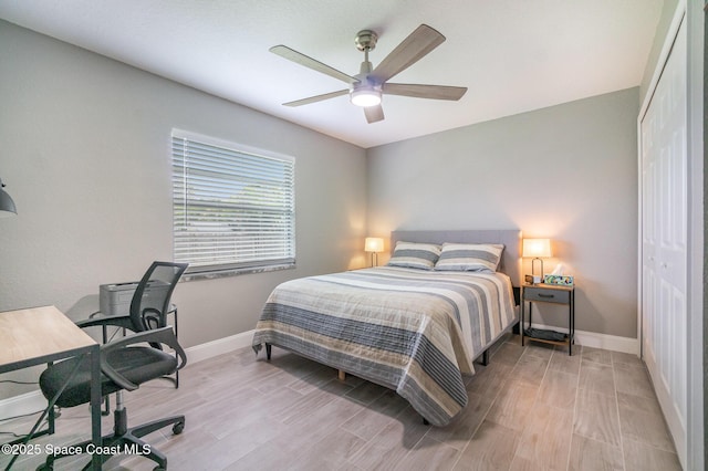 1237 Glenham Dr NE, Palm Bay, FL 32905 - bedroom featuring baseboards, wood finished floors, a closet, a desk, and a ceiling fan