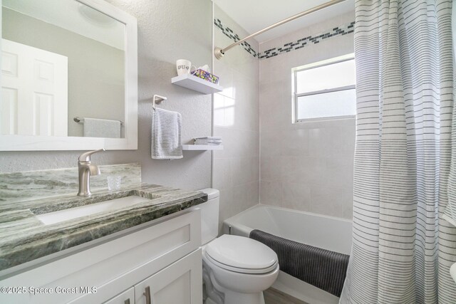 1237 Glenham Dr NE, Palm Bay, FL 32905 - full bathroom featuring vanity, toilet, and shower / bath combination with curtain