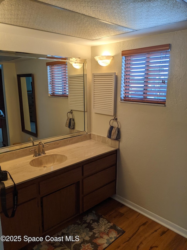 199 Skyline Ct, Satellite Beach, FL 32937 - bathroom with wood finished floors, vanity, and baseboards