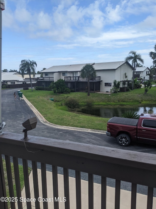 199 Skyline Ct, Satellite Beach, FL 32937 - view of front of property featuring a residential view, a front lawn, and a water view
