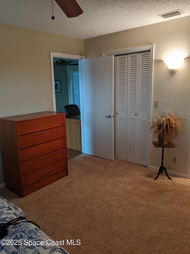 199 Skyline Ct, Satellite Beach, FL 32937 - bedroom with carpet, a textured ceiling, a closet, and ceiling fan