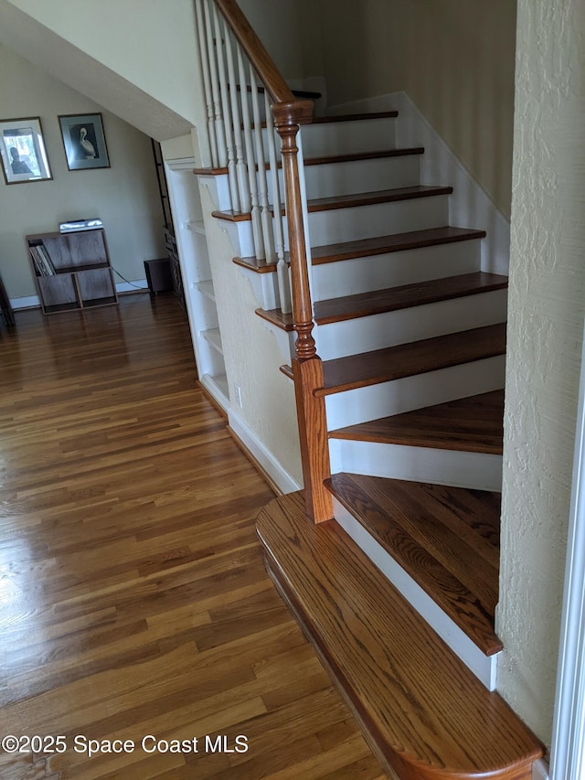 199 Skyline Ct, Satellite Beach, FL 32937 - stairs featuring wood finished floors and baseboards