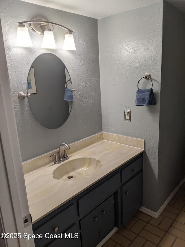 199 Skyline Ct, Satellite Beach, FL 32937 - bathroom featuring vanity and brick patterned flooring