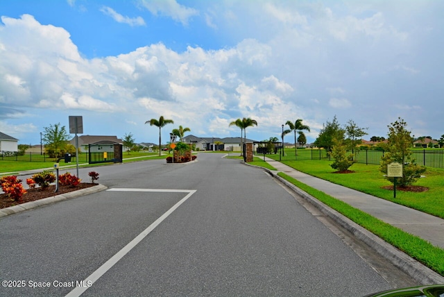 3466 Rixford Way, Palm Bay, FL 32909 - view of asphalt road with curbs, sidewalks, a residential view, and a gated entry