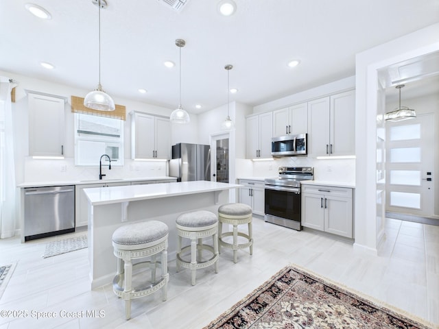 3466 Rixford Way, Palm Bay, FL 32909 - kitchen with appliances with stainless steel finishes, a sink, tasteful backsplash, light countertops, and a kitchen island