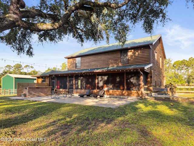 3373 Stratos Ln, Palm Bay, FL 32909 - rear view of house featuring a sunroom, a patio, and roof with shingles