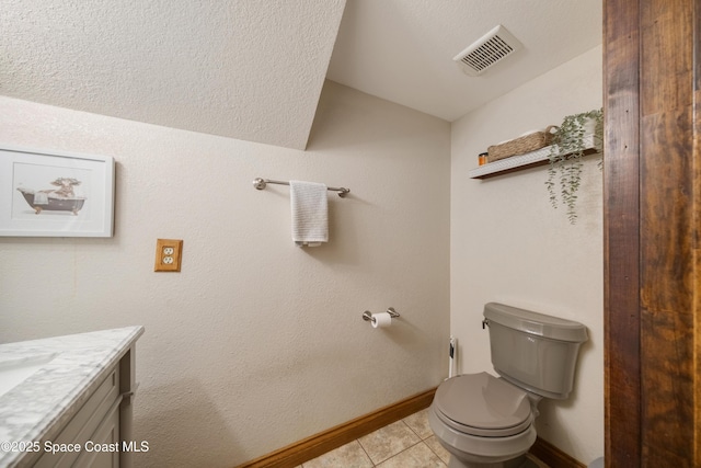 3373 Stratos Ln, Palm Bay, FL 32909 - bathroom with vanity, lofted ceiling, toilet, tile patterned flooring, and baseboards
