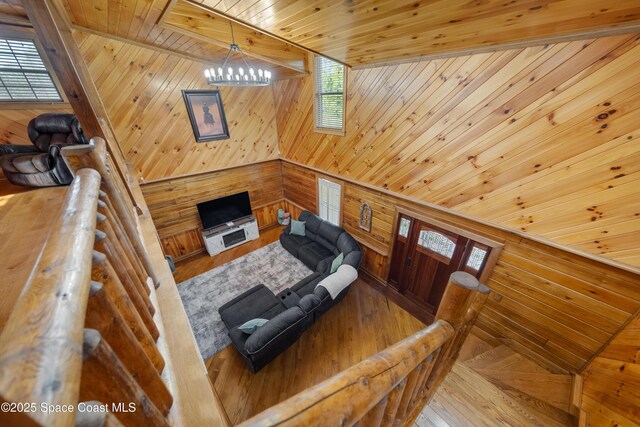 3373 Stratos Ln, Palm Bay, FL 32909 - living area with wood walls, wooden ceiling, a chandelier, and wood finished floors