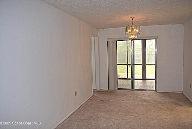 630 Venetian Way, Merritt Island, FL 32953 - carpeted spare room with a chandelier, a textured ceiling, and baseboards