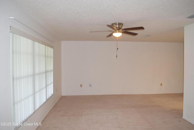 630 Venetian Way, Merritt Island, FL 32953 - spare room featuring light carpet, a ceiling fan, and a textured ceiling