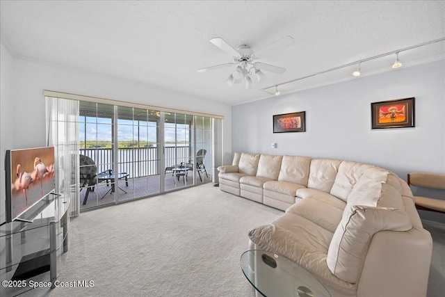 660 S Brevard Ave Unit 1535, Cocoa Beach, FL 32931 - living room featuring carpet, track lighting, a ceiling fan, and a water view