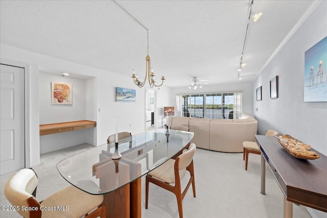 660 S Brevard Ave Unit 1535, Cocoa Beach, FL 32931 - dining room with rail lighting, a chandelier, light carpet, a textured ceiling, and a ceiling fan