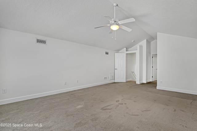 310 Chennault Ln, Rockledge, FL 32955 - carpeted spare room featuring vaulted ceiling, a ceiling fan, and a textured ceiling
