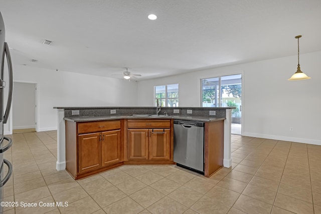 310 Chennault Ln, Rockledge, FL 32955 - kitchen featuring stainless steel dishwasher, ceiling fan, light tile patterned floors, brown cabinetry, and dark stone countertops