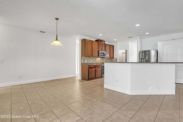 310 Chennault Ln, Rockledge, FL 32955 - kitchen featuring appliances with stainless steel finishes, tasteful backsplash, light tile patterned floors, dark countertops, and brown cabinets