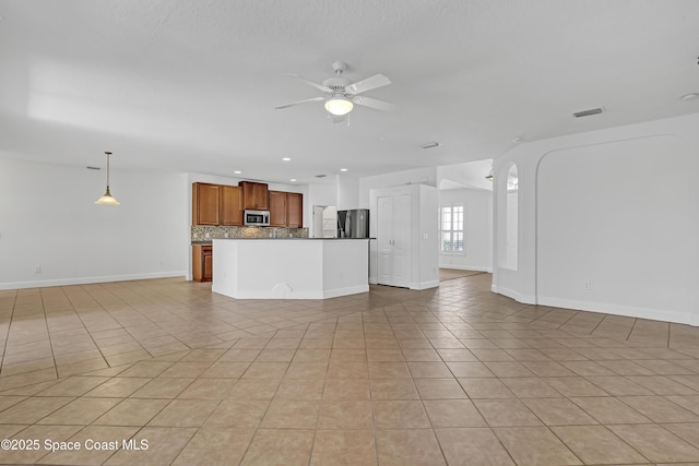 310 Chennault Ln, Rockledge, FL 32955 - unfurnished living room featuring a ceiling fan, light tile patterned flooring, and recessed lighting