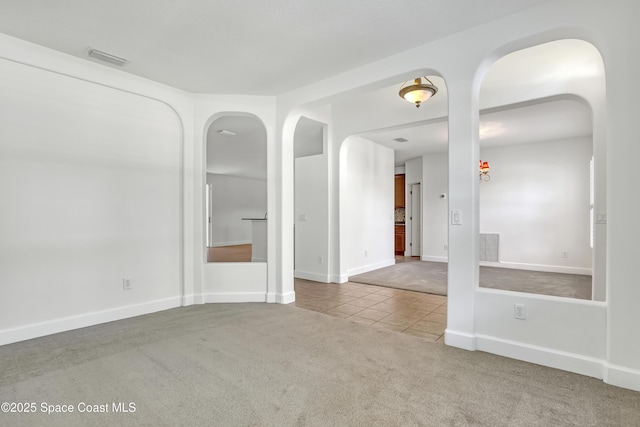 310 Chennault Ln, Rockledge, FL 32955 - carpeted spare room with arched walkways and tile patterned flooring