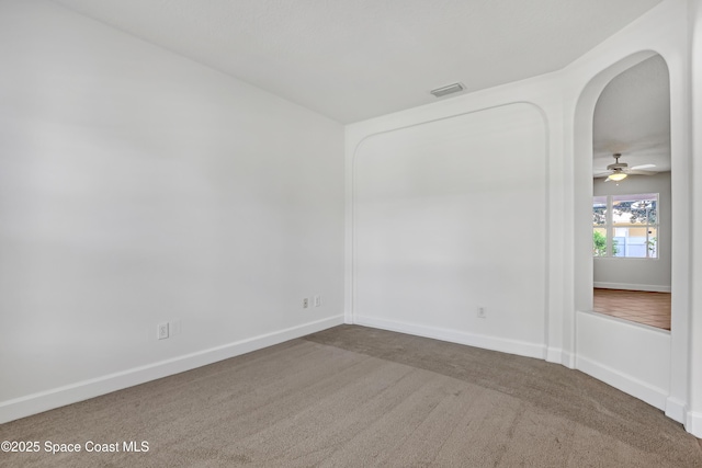 310 Chennault Ln, Rockledge, FL 32955 - unfurnished room featuring carpet flooring, arched walkways, and ceiling fan