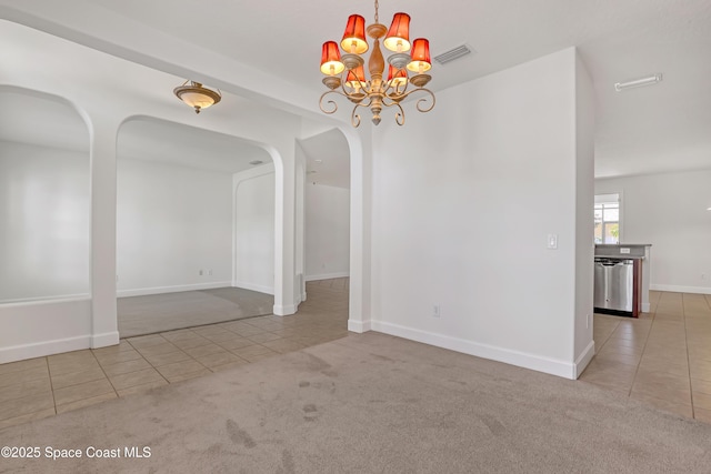 310 Chennault Ln, Rockledge, FL 32955 - unfurnished dining area with tile patterned floors, arched walkways, a chandelier, and carpet