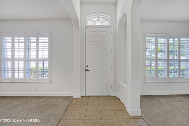 310 Chennault Ln, Rockledge, FL 32955 - entrance foyer with arched walkways, light carpet, and light tile patterned floors