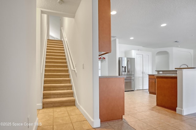 310 Chennault Ln, Rockledge, FL 32955 - stairway with tile patterned flooring, a textured ceiling, recessed lighting, and arched walkways