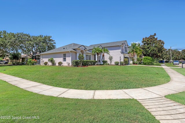 310 Chennault Ln, Rockledge, FL 32955 - ranch-style house featuring a front yard and stucco siding