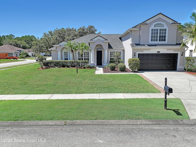 310 Chennault Ln, Rockledge, FL 32955 - view of front facade with stucco siding, concrete driveway, a garage, and a front yard