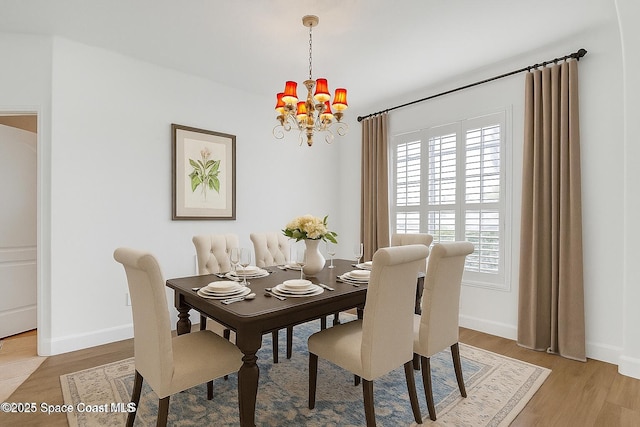 310 Chennault Ln, Rockledge, FL 32955 - dining room with a chandelier and light wood-type flooring