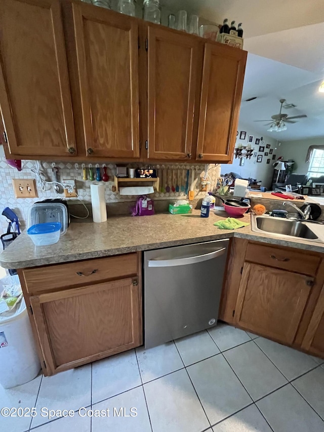 237 Jacaranda Ave NW, Palm Bay, FL 32907 - kitchen with dishwasher, a sink, ceiling fan, light countertops, and brown cabinetry