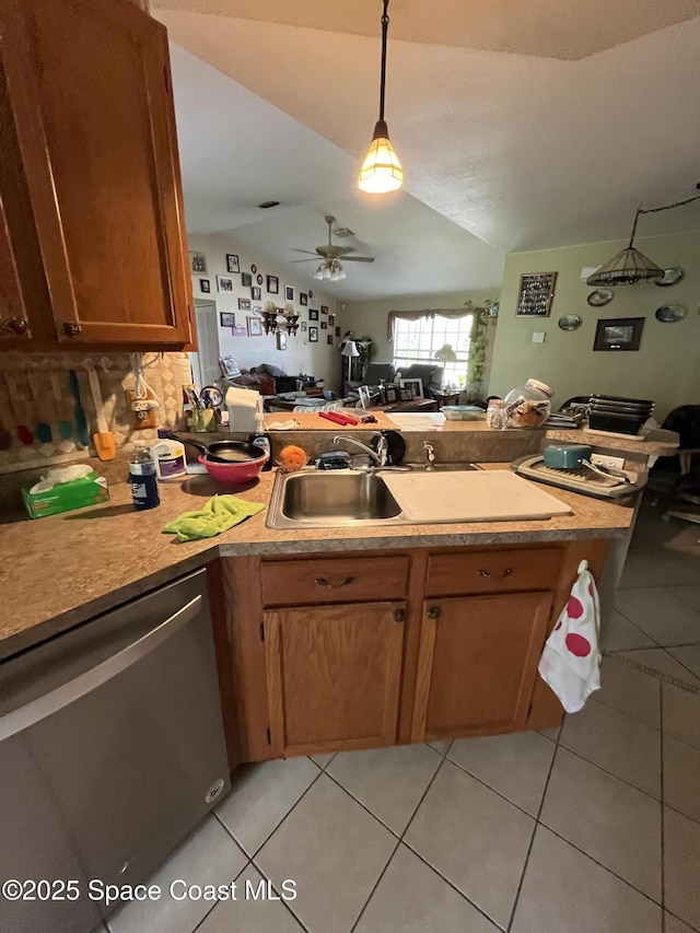237 Jacaranda Ave NW, Palm Bay, FL 32907 - kitchen with dishwasher, a peninsula, light tile patterned floors, a ceiling fan, and lofted ceiling