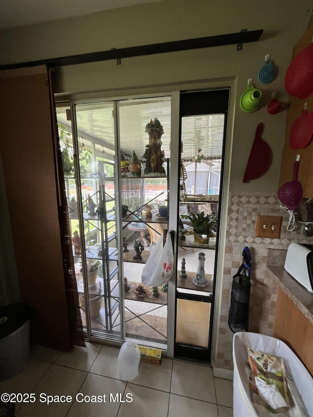 237 Jacaranda Ave NW, Palm Bay, FL 32907 - doorway to outside with light tile patterned flooring