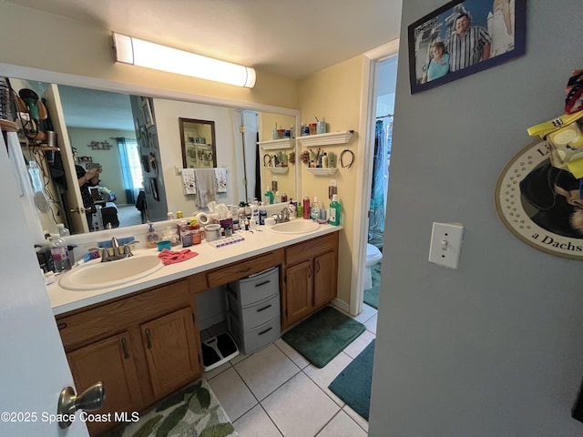 237 Jacaranda Ave NW, Palm Bay, FL 32907 - full bathroom featuring toilet, double vanity, and tile patterned floors