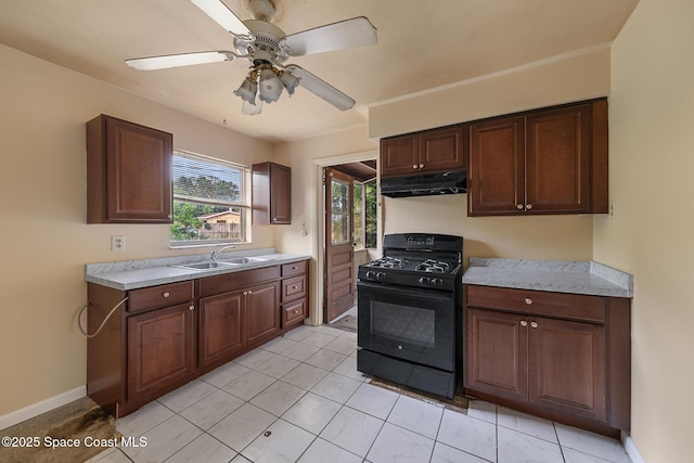 3774 Brockington Cir, Cocoa, FL 32926 - kitchen with black gas range oven, under cabinet range hood, light countertops, a ceiling fan, and light tile patterned floors