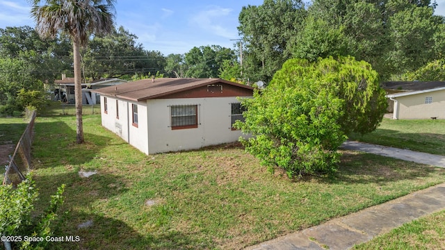 3774 Brockington Cir, Cocoa, FL 32926 - view of side of property featuring a yard and stucco siding