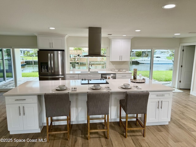 57 Riverview Ln, Cocoa Beach, FL 32931 - kitchen with appliances with stainless steel finishes, island exhaust hood, a sink, plenty of natural light, and recessed lighting