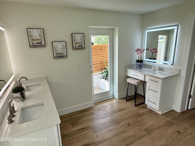 57 Riverview Ln, Cocoa Beach, FL 32931 - full bathroom featuring wood finished floors, double vanity, and baseboards