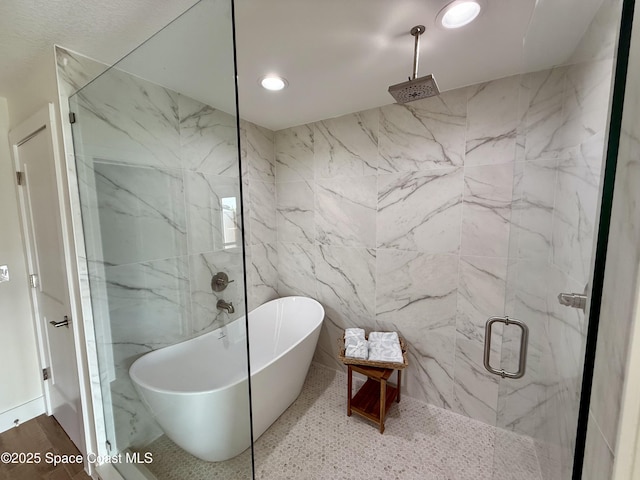 57 Riverview Ln, Cocoa Beach, FL 32931 - bathroom featuring a marble finish shower, a soaking tub, and recessed lighting