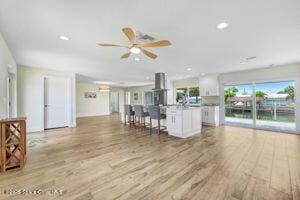 57 Riverview Ln, Cocoa Beach, FL 32931 - living room featuring light wood-type flooring, a ceiling fan, and recessed lighting