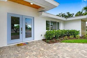 57 Riverview Ln, Cocoa Beach, FL 32931 - entrance to property with french doors and stucco siding