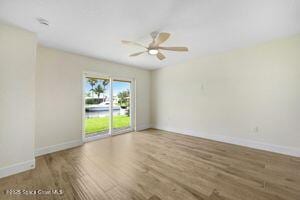 57 Riverview Ln, Cocoa Beach, FL 32931 - unfurnished room featuring wood finished floors and ceiling fan