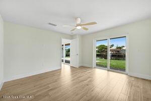 57 Riverview Ln, Cocoa Beach, FL 32931 - empty room with wood finished floors and a ceiling fan