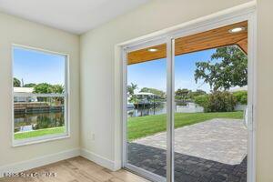 57 Riverview Ln, Cocoa Beach, FL 32931 - doorway with a water view and light wood-style floors