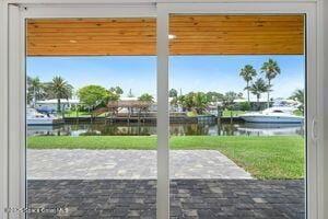 57 Riverview Ln, Cocoa Beach, FL 32931 - doorway to outside featuring a water view